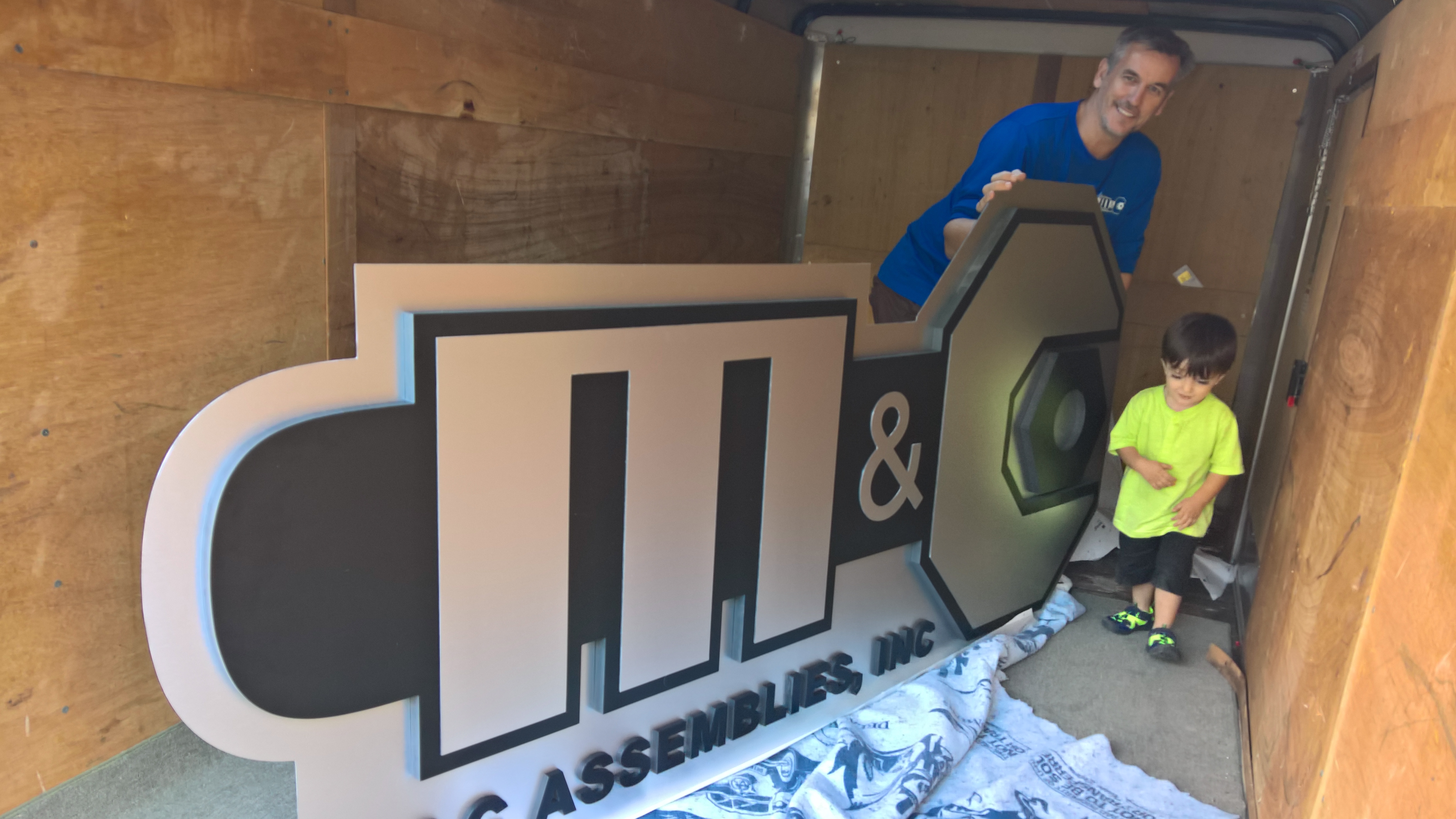 Clifton and Wyatt unveiling the first M&C office sign